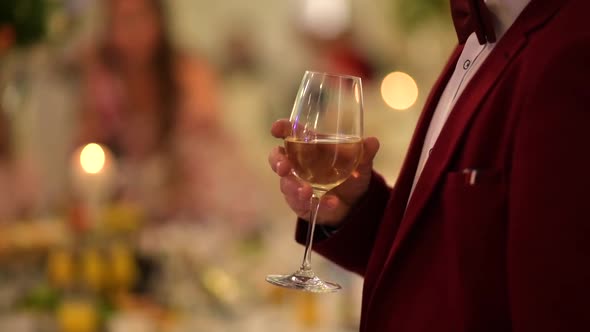 Gentleman in Burgundy Tuxedo with Glass of Wine