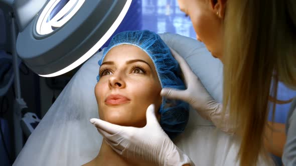 Doctor examining female patient skin