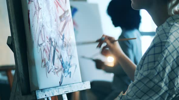 A Lady is Painting a Multicolour Picture During an Art Class