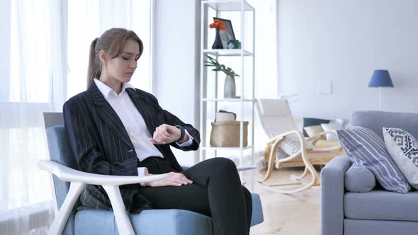 Woman Waiting in Office Checking Time on Smartwatch