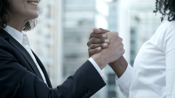 Smiling Caucasian Woman Shaking Hands with Colleague