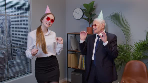 Two Joyful Collegues in Formal Suits Dancing Victory Dance Celebrating Success of Business Project