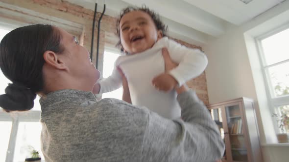 Happy Mother Holding Adorable Toddler alt