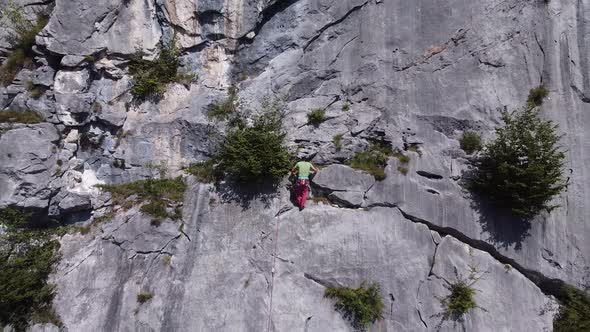 Athlete free climbing on mountain crag