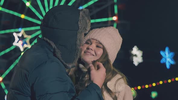 Man Touches Girl Hair By Ferris Wheel at Fair Slow Motion