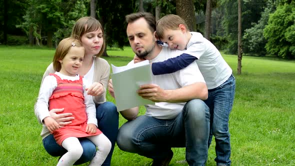 Family, Middle Couple in Love, Cute Girl and Small Boy, Read Document in the Park