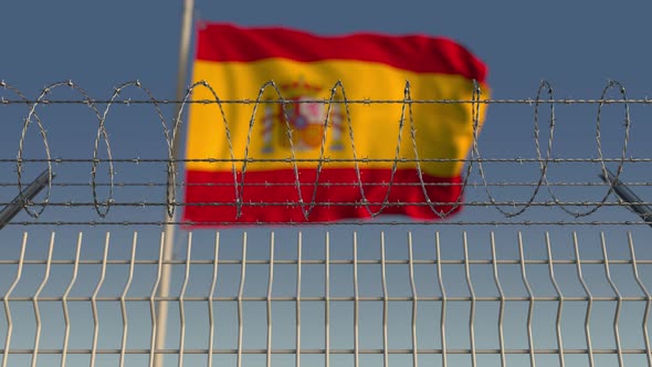 Barbed Wire Against Waving Flag of Spain