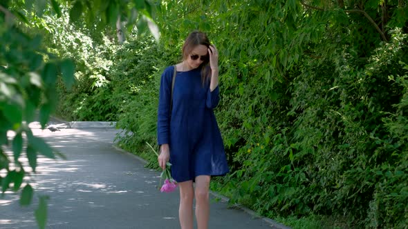 Young Woman Walking in the Park