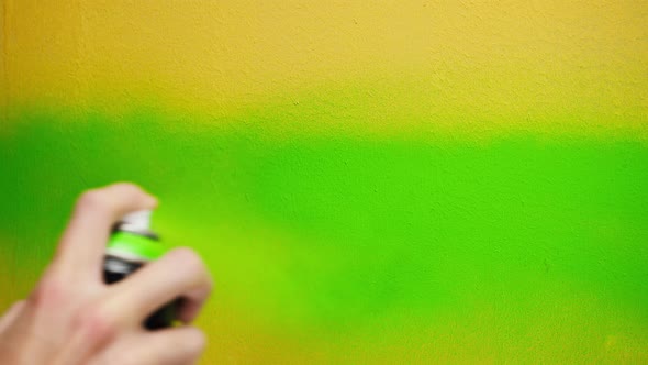 Painting Walls with Yellow Paint Using Brush Closeup