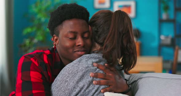 Close Up of Happy Lovely Beloved Coupe Young Man and Beautiful Woman Hugging Together Sitting