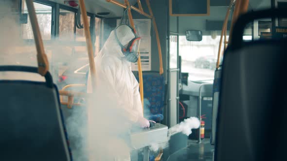 Male Worker Disinfects a Bus From Inside To Kill Virus