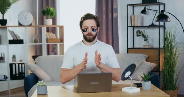 30-Aged Bearded Guy with Hydrogel Refreshing Patches Under Eyes Relaxing with Closed Eyes