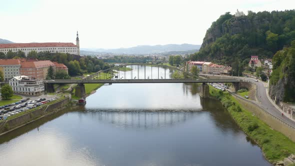 Tyršův bridge in Děčín, Czechia, chateau on left shore, drone shot.