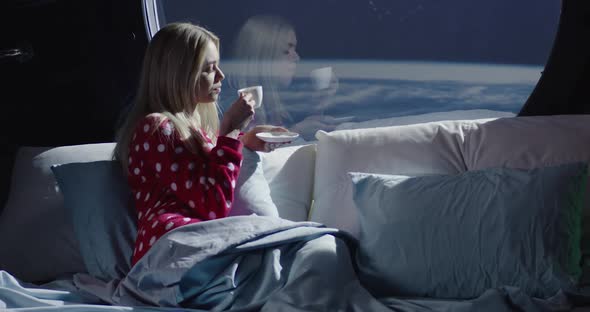 Woman Enjoying View and Coffee in a Spaceship