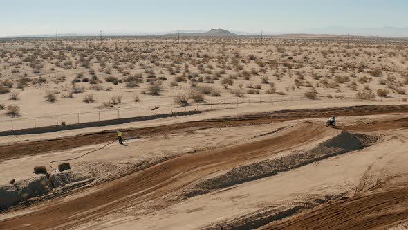 Aerial Tracking Pan, Motocross rider jumping and catching air on desert circuit