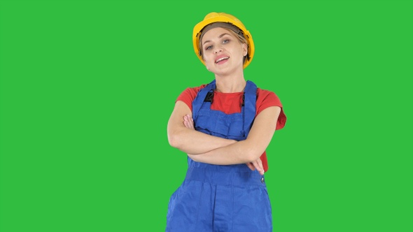 Smiling constructor worker woman standing and changing