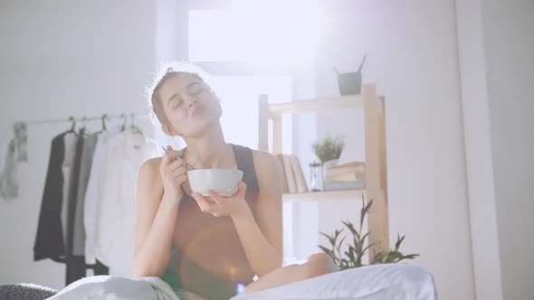 Young Lady Having Breakfast in Bed in Slowmotion