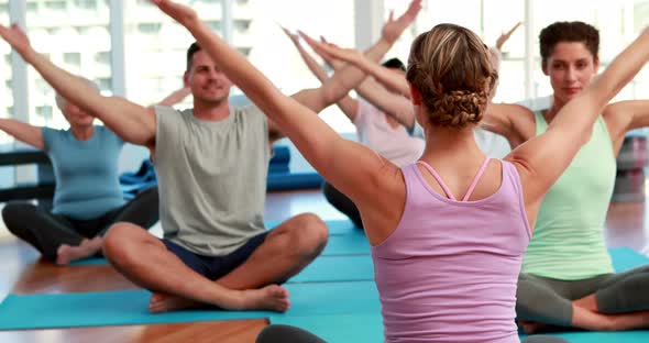 Yoga Class Sitting in Lotus Position Together