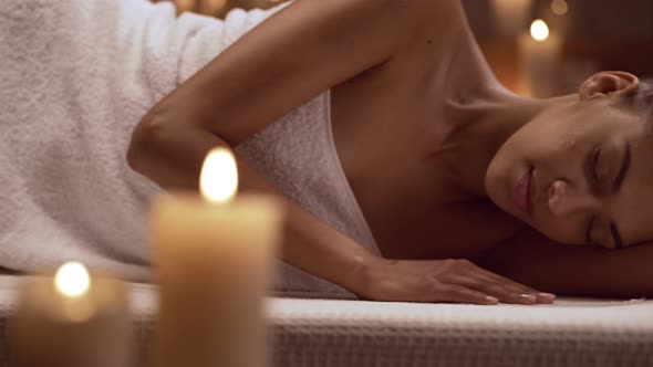 Young Beautiful African American Girl Lying Sidelong on Massage Table Ready for Relax