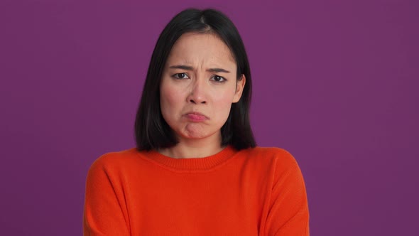 Offended woman in red sweater looking to the side