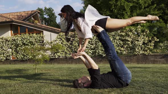 Modern dancers practicing front bird in summer garden