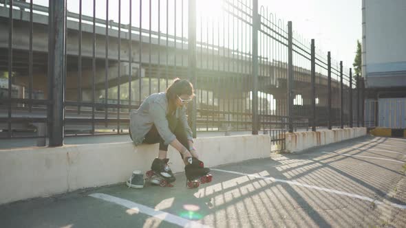 Attractive Young Woman with Roller Skating on the Street Having Fun Time at Sunset