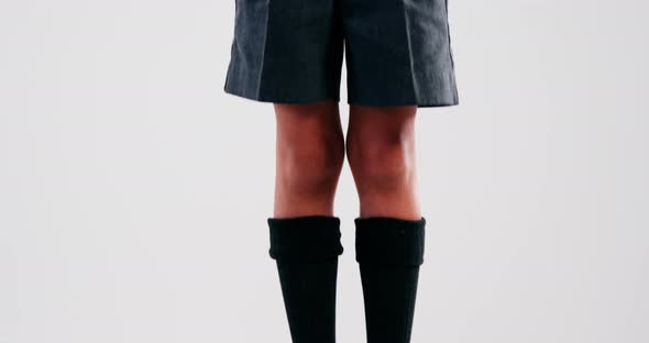 Excited schoolboy standing on stack of books