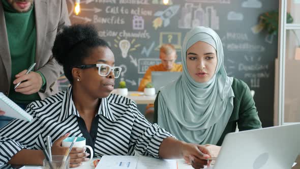 Female Colleagues Talking Then Consulting Male Coworker in Shared Office