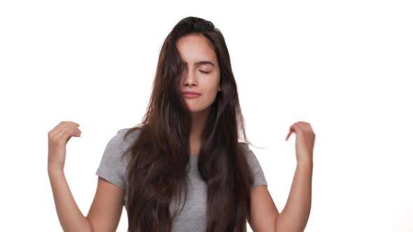 Portrait of Sexy Brunette Womanl with Long Dark Hair Dancing on Camera with Closed Eyes Smiling