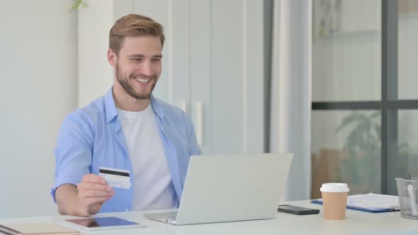 Successful Online Payment on Laptop By Young Creative Man