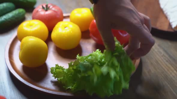 Spread Tomatoescucumberslettuce and Sweet Pepper on Wooden Round Cutting Board