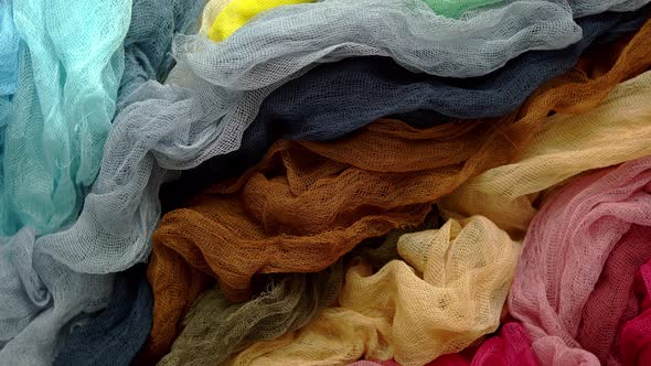 Top View of Multi Colored Gauze Fabric Placed on a Table. Flat Lay. Trendy Rainbow Color Background