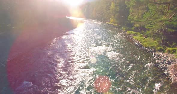 Low Altitude Flight Over Fresh Fast Mountain River with Rocks at Sunny Summer Morning