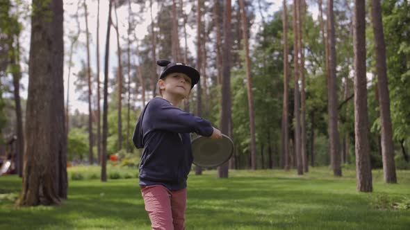 Slow Motion Shot Of A Cute Girl Throwing A Frisbee