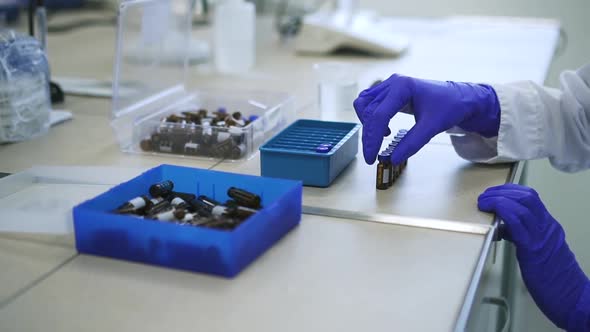 Woman Lab Assistant is Working with Drug Samples Sitting at Table in Pharmaceutical Company Spbd