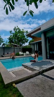 Couple Men and Women on a Luxury Vacation at a Pool Villa