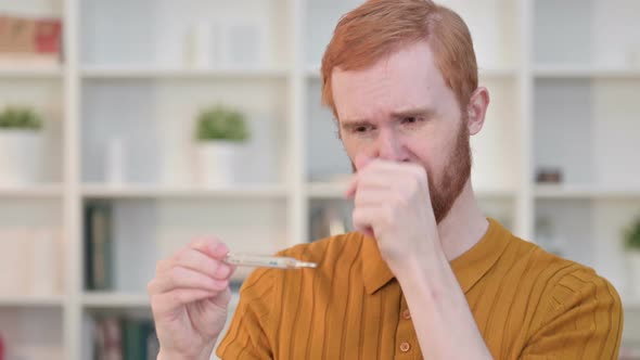 Portrait of Sick Redhead Man Checking Temperature By Thermometer 