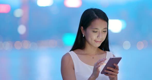 Woman use of mobile phone at night