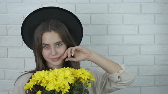 Charming young girl with flowers.