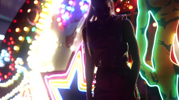 Woman Dancing In Pvc And Posing By Neon Lights