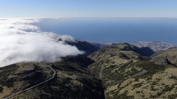 Clouds over Madeira mountains, Funchal city in the background, Portugal