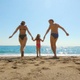 Happy family run on sand into the sea - VideoHive Item for Sale