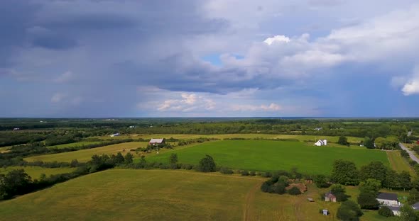 Aerial flying over the countryside on a rainy, summer afternoon