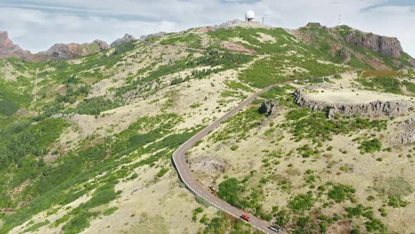 A Car Passing High Terrain with Endemic Vegetation As Seen From Top