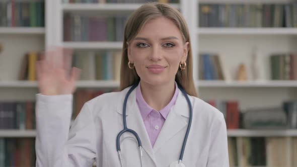 Portrait of Lady Doctor Waving Hand for Hello Welcoming