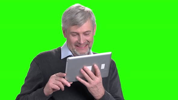 Cheerful Middle-aged Man Talking Via Pc Tablet.