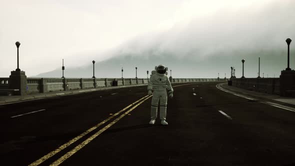 Astronaut Walks in the Middle of a Road