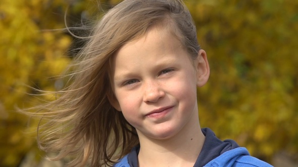 Closeup portrait of happy adorable child girl smiling. Slow motion