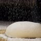 The white flour is falling on the dough in slow motion - VideoHive Item for Sale