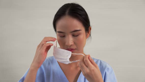 Young Asian Woman Take Off Face Mask Removing From Face